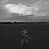 the girl beneath the petals of clouds
